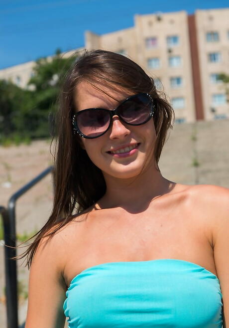 Excellent youthful Semmi A in skirt exhibiting her butt and spreading her legs outdoor