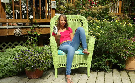 Gracile american young Liza Rowe in jeans exhibiting tiny tits and loving sex toy outdoor