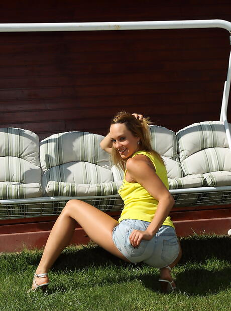 Stunning american teen Blue Angel in shorts reveals her butt and toys her twat outside